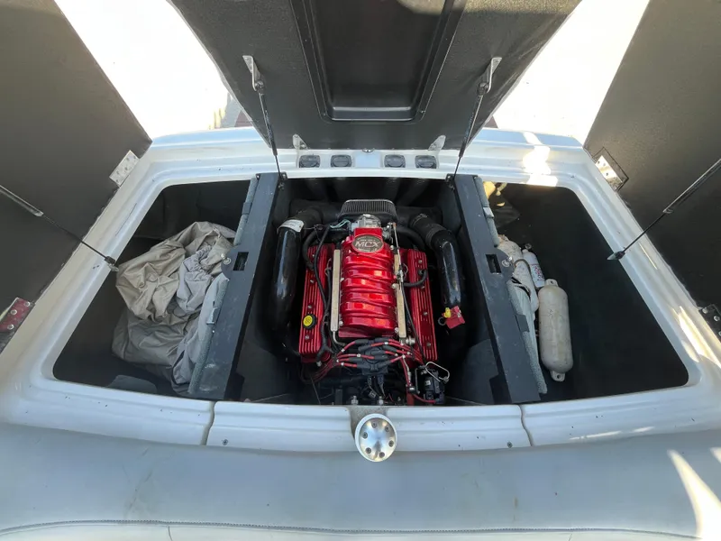 Slide: The Image of 2004 MasterCraft 210 Maristar engine compartment with red engine and storage areas. - 17