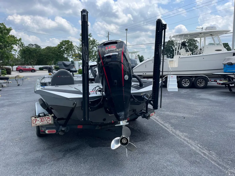 Slide: The Image of 2022 Vexus AVX189 boat with outboard motor, parked on a trailer in a lot. - 3