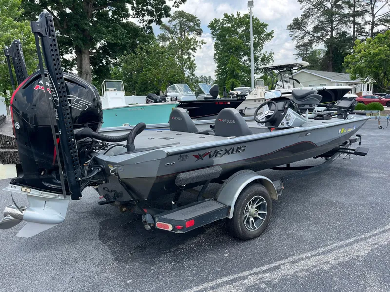 Slide: The Image of 2022 Vexus AVX189 boat on trailer, parked outdoors with trees in background. - 6