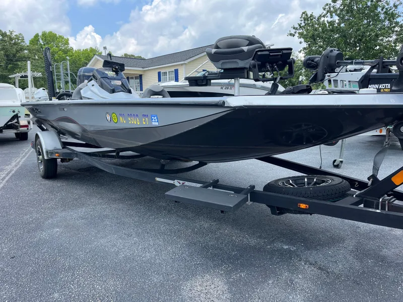 Slide: The Image of 2022 Vexus AVX189 boat on trailer, parked outdoors under cloudy sky. - 9