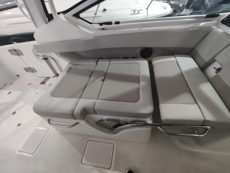 Slide: The Image of 2021 Boston Whaler 280 Vantage interior seating area with cushioned seats and sleek design. - 13