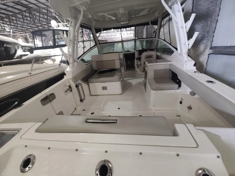 Slide: The Image of 2021 Boston Whaler 280 Vantage boat interior with seating and helm in a showroom. - 14