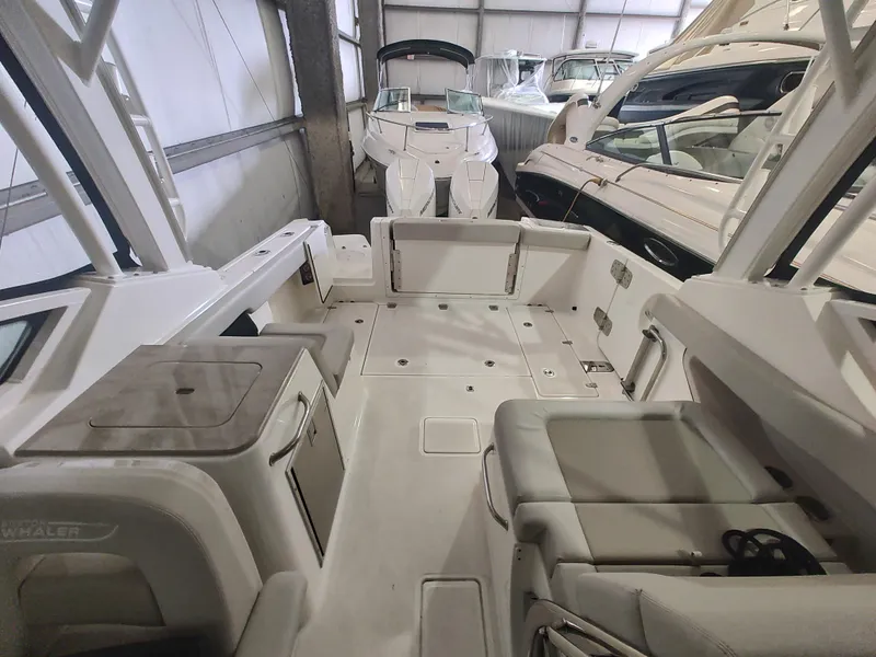 Slide: The Image of 2021 Boston Whaler 280 Vantage boat interior, showcasing spacious seating and storage areas. - 16
