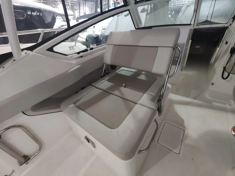 Slide: The Image of 2021 Boston Whaler 280 Vantage interior with cushioned seating and sleek design. - 17