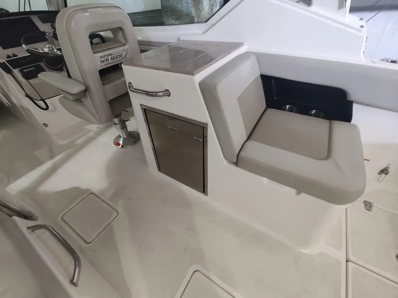 Slide: The Image of Interior of 2021 Boston Whaler 280 Vantage boat, featuring seating and storage area. - 18