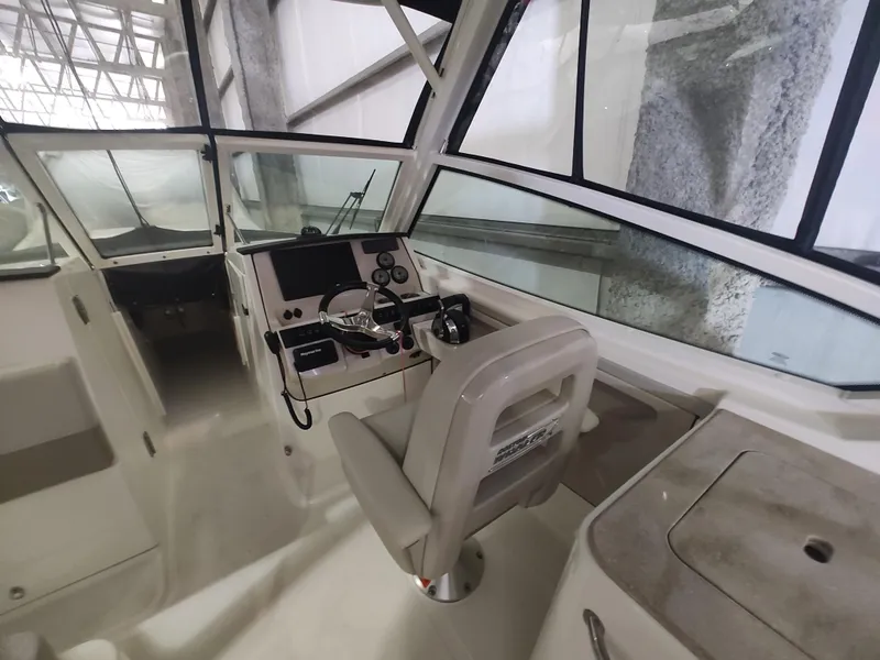 Slide: The Image of 2021 Boston Whaler 280 Vantage boat interior with helm and seating area. - 19