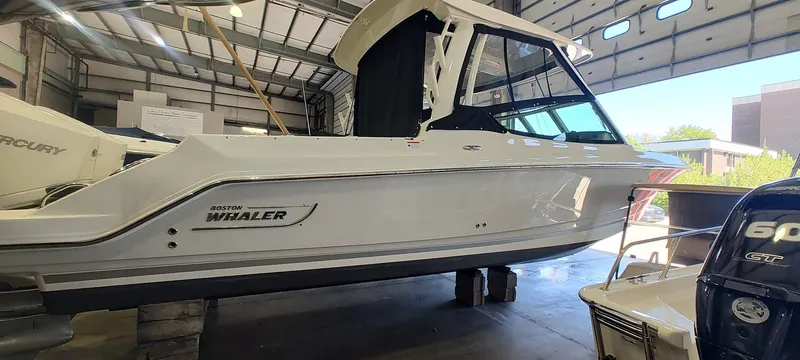 Slide: The Image of 2021 Boston Whaler 280 Vantage boat in a garage setting. - 2