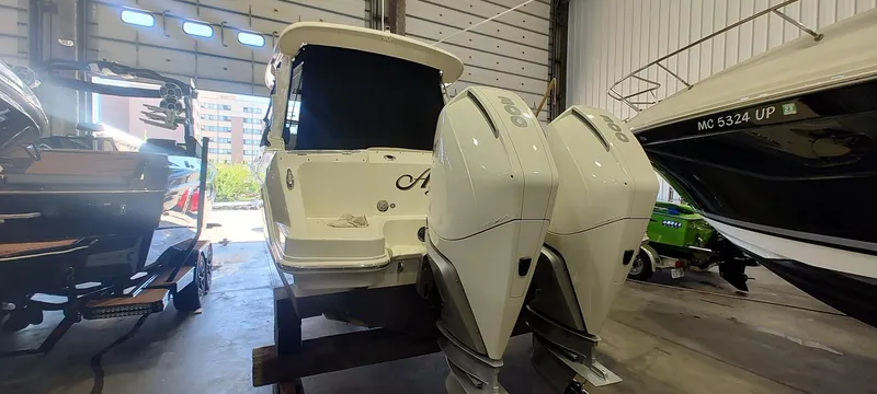 Slide: The Image of 2021 Boston Whaler 280 Vantage boat with dual engines in a storage facility. - 21