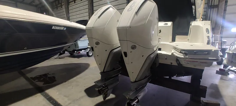 Slide: The Image of 2021 Boston Whaler 280 Vantage with dual outboard engines in a storage facility. - 22