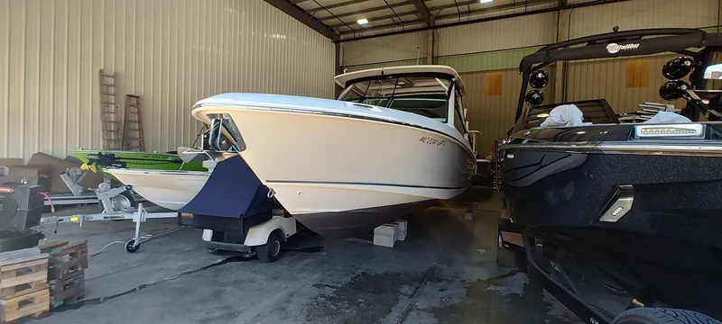 Slide: The Image of 2021 Boston Whaler 280 Vantage boat stored in a spacious indoor facility. - 5