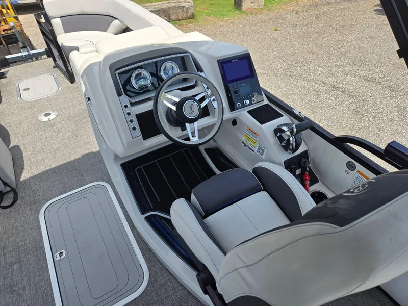 Slide: The Image of 2022 Barletta Corsa 23U boat cockpit with modern steering and control panel. - 12