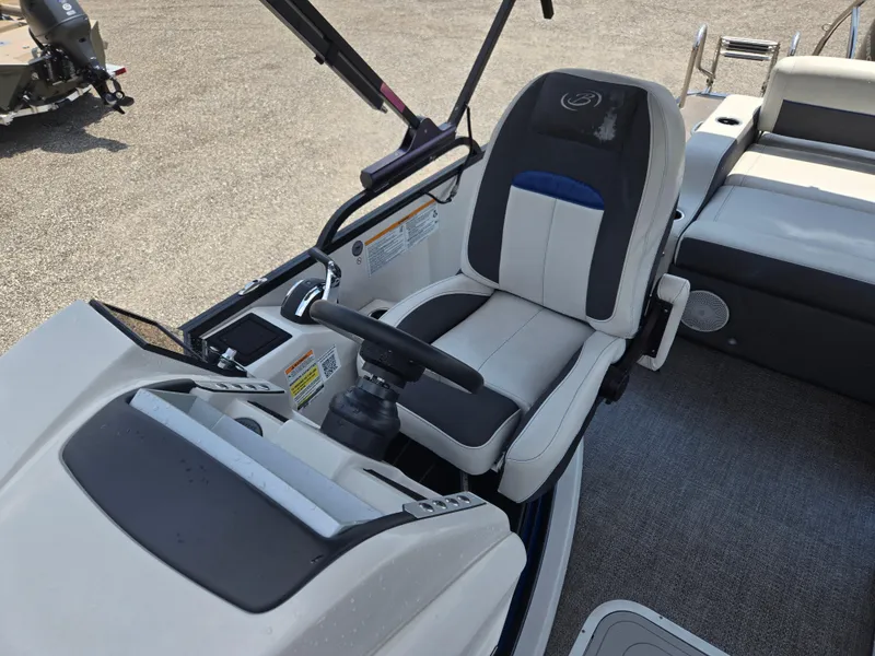 Slide: The Image of Captain's seat of 2022 Barletta Corsa 23U pontoon boat, featuring modern controls and comfortable design. - 13