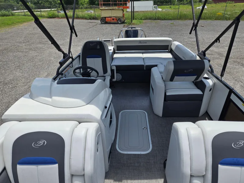Slide: The Image of 2022 Barletta Corsa 23U pontoon boat interior with plush seating and steering console. - 15