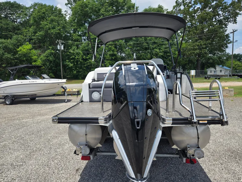 Slide: The Image of 2022 Barletta Corsa 23U pontoon boat with sleek design, parked outdoors. - 19