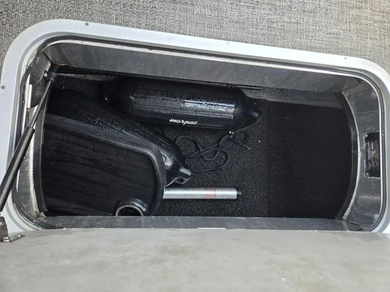 Slide: The Image of Storage compartment of 2022 Barletta Corsa 23U boat with fender and equipment. - 4