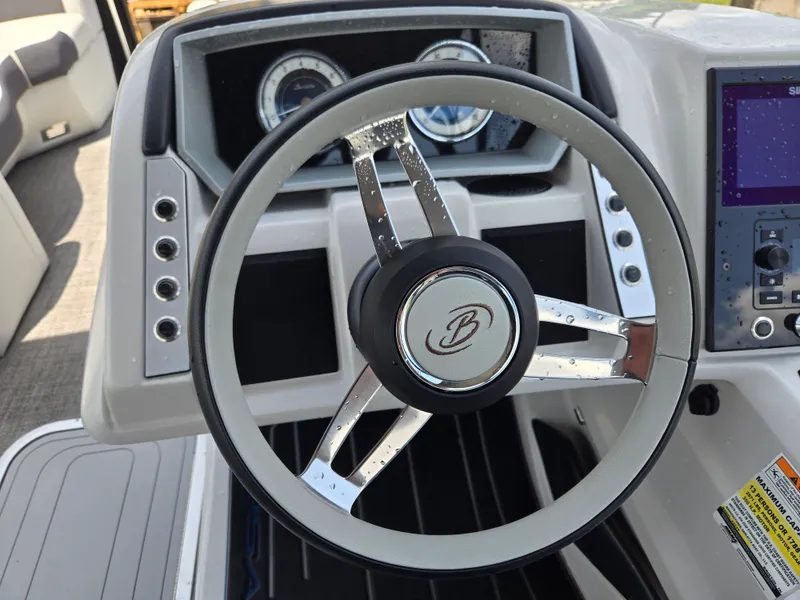 Slide: The Image of Steering wheel of 2022 Barletta Corsa 23U boat with dashboard controls. - 5