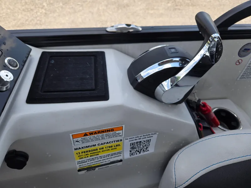 Slide: The Image of Control panel of 2022 Barletta Corsa 23U boat with throttle and capacity warning label. - 6