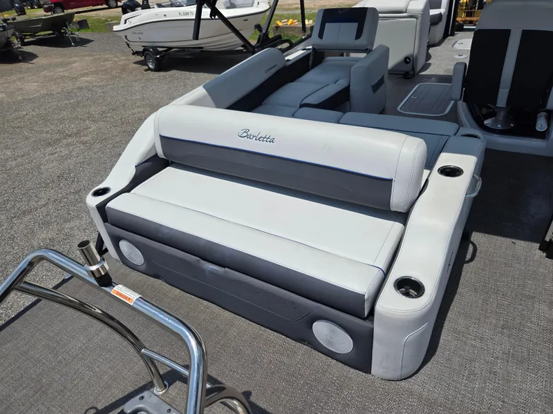 Slide: The Image of 2022 Barletta Corsa 23U boat interior with gray seating and cup holders. - 8