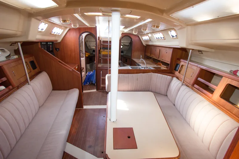 Slide: The Image of Interior of 1989 Hunter 37.5 sloop, featuring spacious seating and wooden cabinetry. - 10