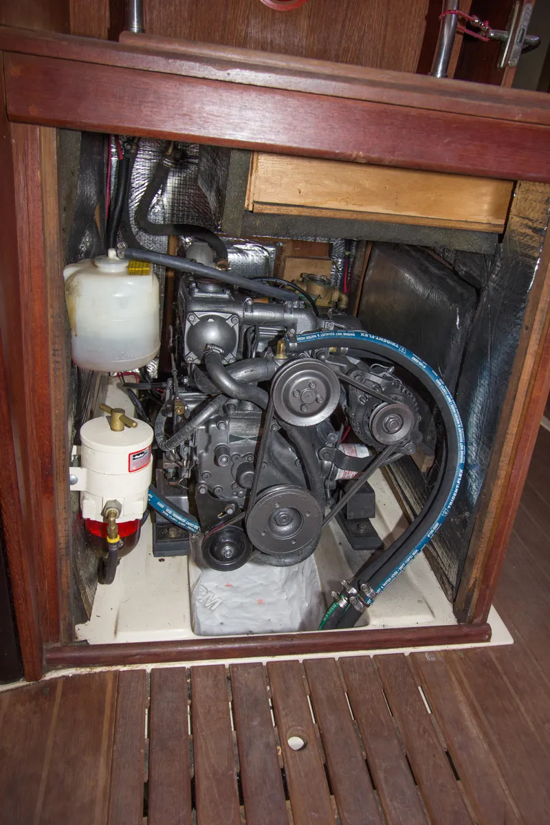 Slide: The Image of Engine compartment of a 1989 Hunter 37.5 sloop, showcasing mechanical components and hoses. - 20