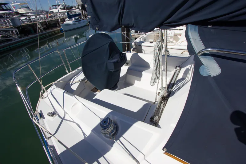 Slide: The Image of 1989 Hunter 37.5 sloop sailboat cockpit with covered steering wheel, docked in marina. - 22
