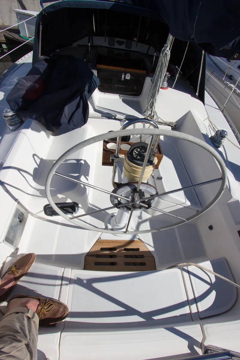 Slide: The Image of Cockpit of 1989 Hunter 37.5 sloop with steering wheel and navigation instruments. - 23