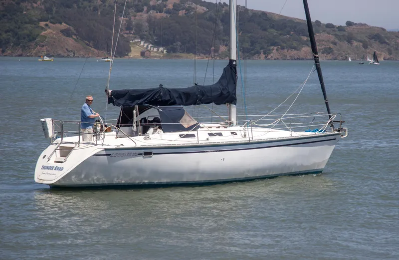 Slide: The Image of 1989 Hunter 37.5 sloop sailing on calm waters with scenic background. - 3