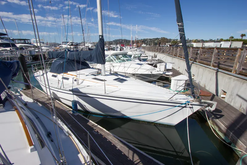 Slide: The Image of 1989 Hunter 37.5 sloop docked at marina under clear blue sky. - 4