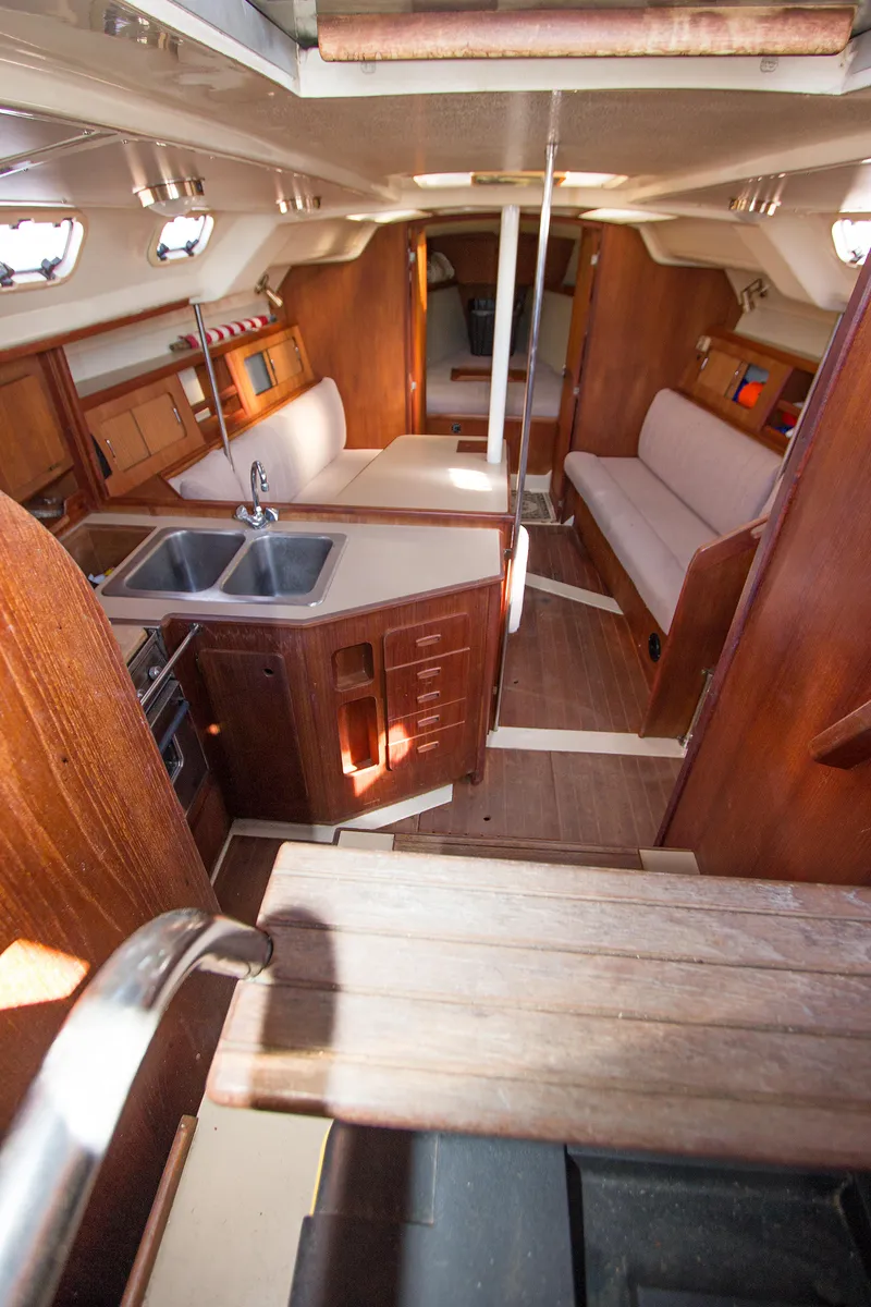 Slide: The Image of Interior of 1989 Hunter 37.5 sloop, featuring wood cabinetry and seating. - 7