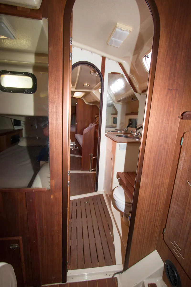 Slide: The Image of Interior of 1989 Hunter 37.5 sloop, featuring wood paneling and compact living space. - 18