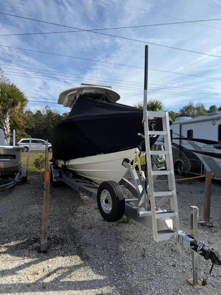 Slide: The Image of 2023 Regulator 28 boat on trailer, covered, parked outdoors. - 19
