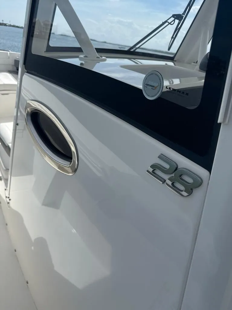 Slide: The Image of 2023 Regulator 28 boat, sleek design with chrome accents and modern features. - 20