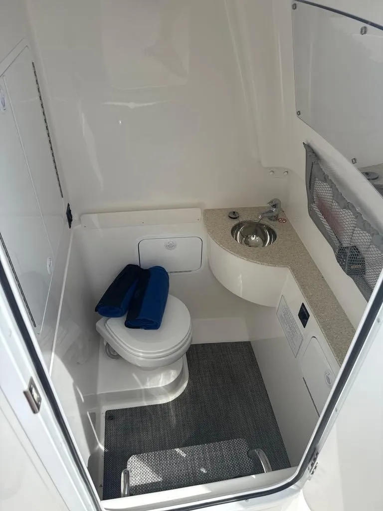 Slide: The Image of 2023 Regulator 28 boat interior with toilet and sink. - 22