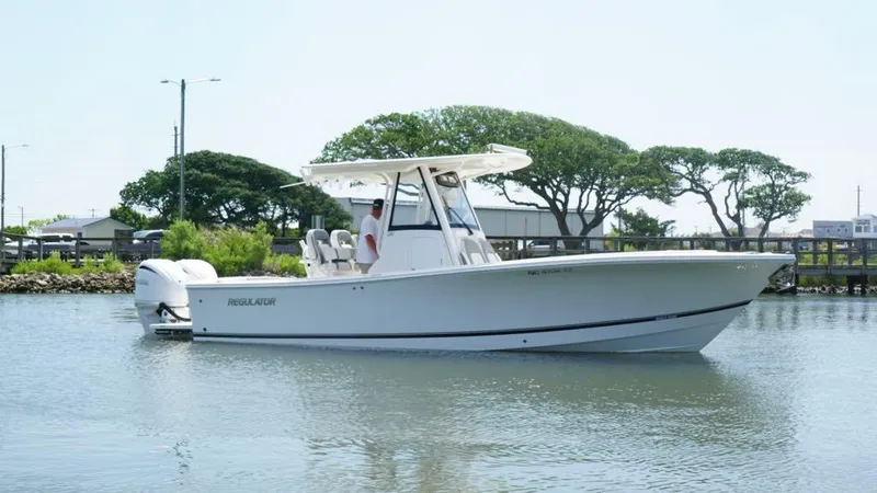 Slide: The Image of 2023 Regulator 28 boat on calm water with trees in the background. - 4