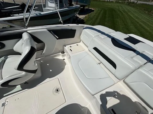 Slide: The Image of 2017 Chaparral 19 H20 Sport boat interior with white seating and black accents. - 12