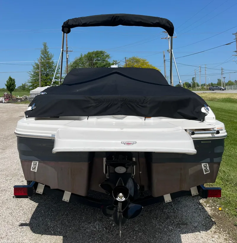 Slide: The Image of 2017 Chaparral 19 H20 Sport boat, rear view with cover, parked outdoors. - 4