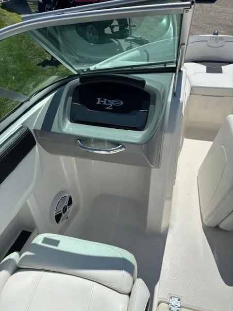 Slide: The Image of 2017 Chaparral 19 H20 Sport boat interior with seating and storage compartment. - 7