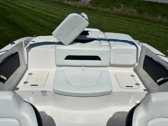 Slide: The Image of 2017 Chaparral 19 H20 Sport boat interior with white seating and open storage compartments. - 9