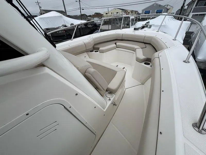 Slide: The Image of 2019 Boston Whaler 250 Outrage boat interior with cushioned seating and cup holders. - 12