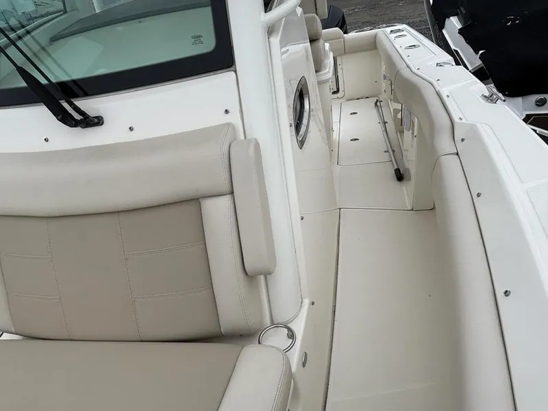 Slide: The Image of 2019 Boston Whaler 250 Outrage boat interior with beige seating and white deck. - 14
