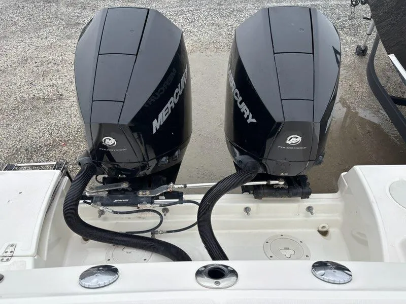 Slide: The Image of Twin Mercury outboard engines on a 2019 Boston Whaler 250 Outrage boat. - 19