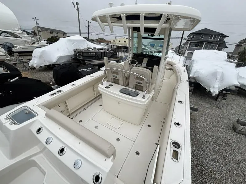 Slide: The Image of 2019 Boston Whaler 250 Outrage boat with spacious deck and modern helm station. - 5