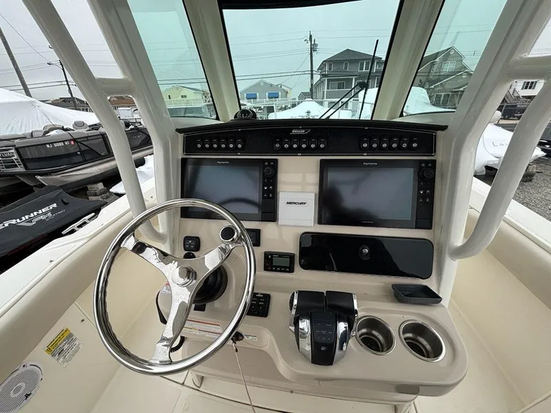 Slide: The Image of 2019 Boston Whaler 250 Outrage helm with dual displays and steering wheel. - 6