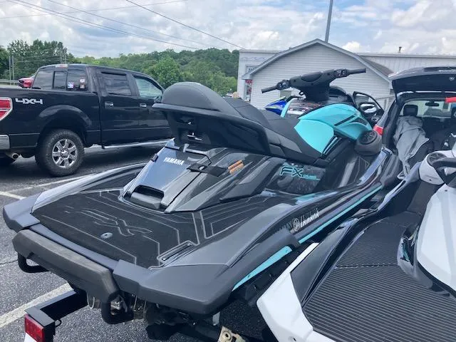 Slide: The Image of 2021 Yamaha WaveRunner VX Deluxe jet ski parked on a trailer in a lot. - 11