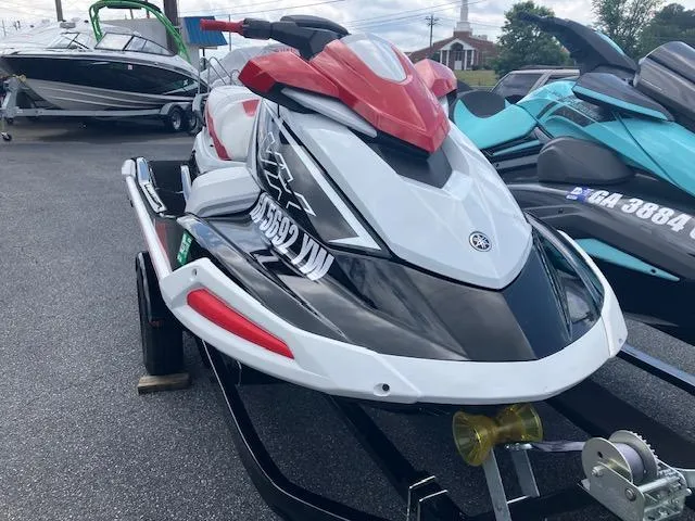 Slide: The Image of 2021 Yamaha WaveRunner VX Deluxe jet ski on trailer, parked outdoors. - 2