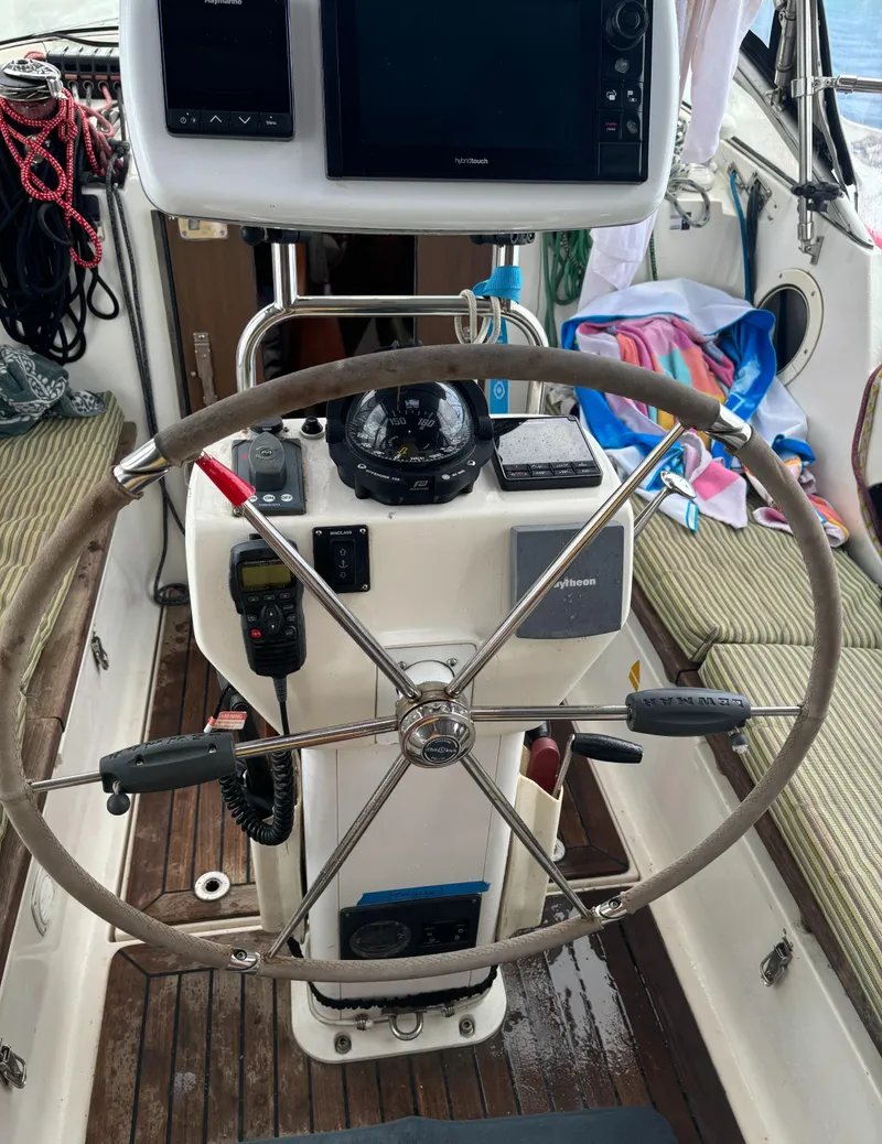 Slide: The Image of Steering wheel and controls of a 2001 Dragonfly 1200 sailboat cockpit. - 11