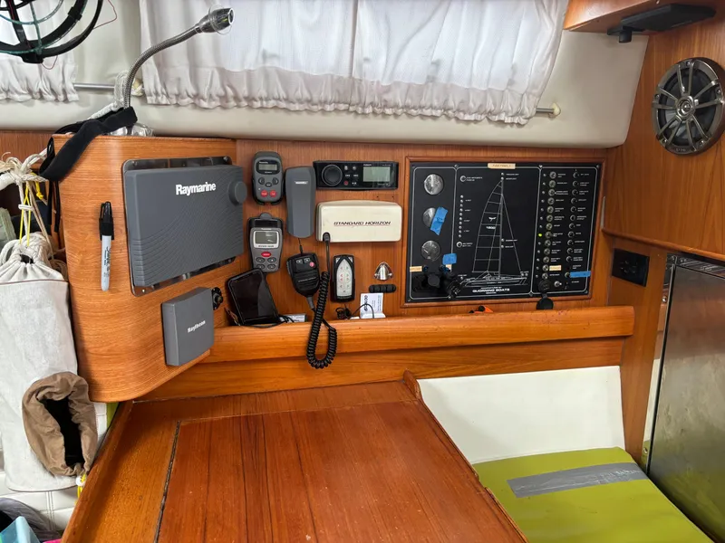 Slide: The Image of Navigation equipment and control panel inside a Dragonfly 1200 sailboat, model year 2001. - 16