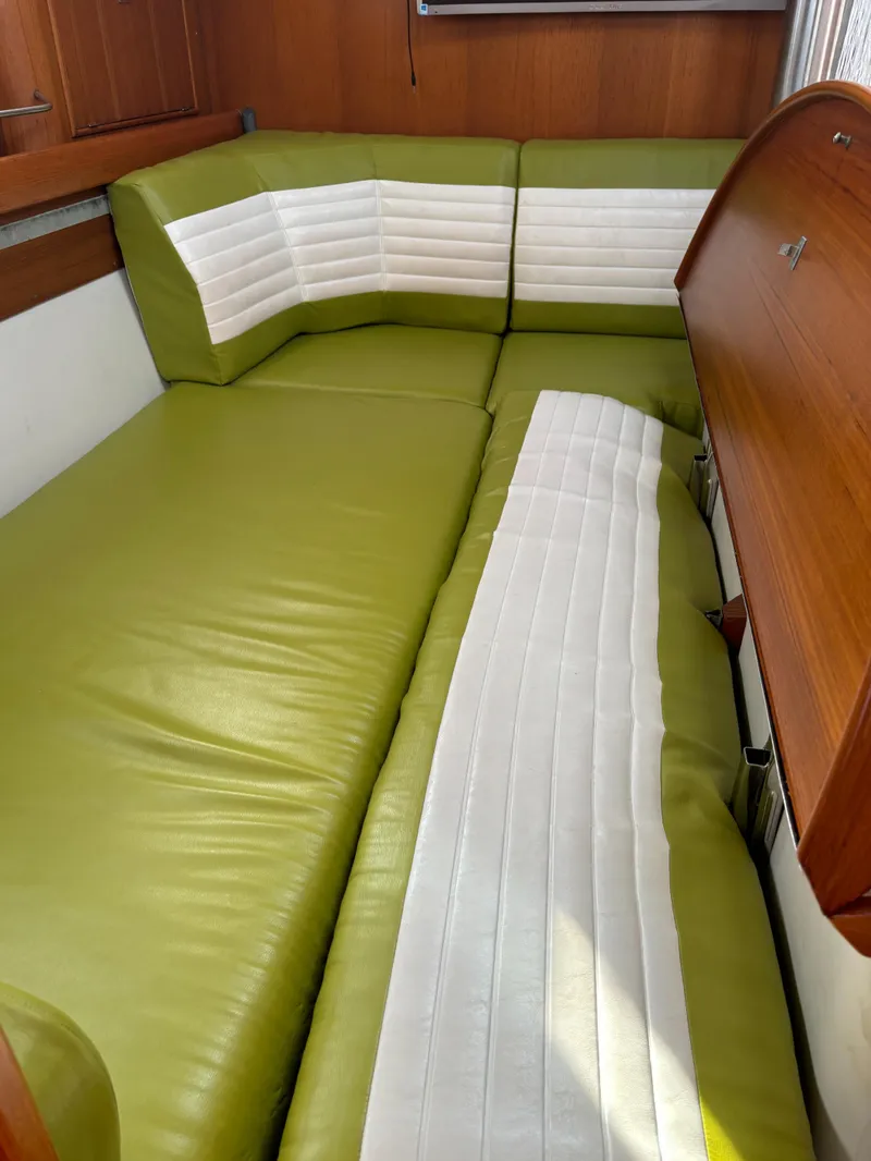Slide: The Image of Green and white cushioned seating in a 2001 Dragonfly 1200 boat interior. - 20