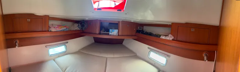 Slide: The Image of Interior cabin of a 2001 Dragonfly 1200 sailboat with wooden storage and cozy seating. - 22