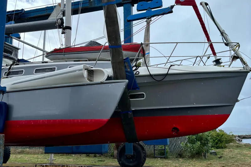 Slide: The Image of Sailboat on lift, Dragonfly 1200 model, 2001, with red and gray hull. - 5